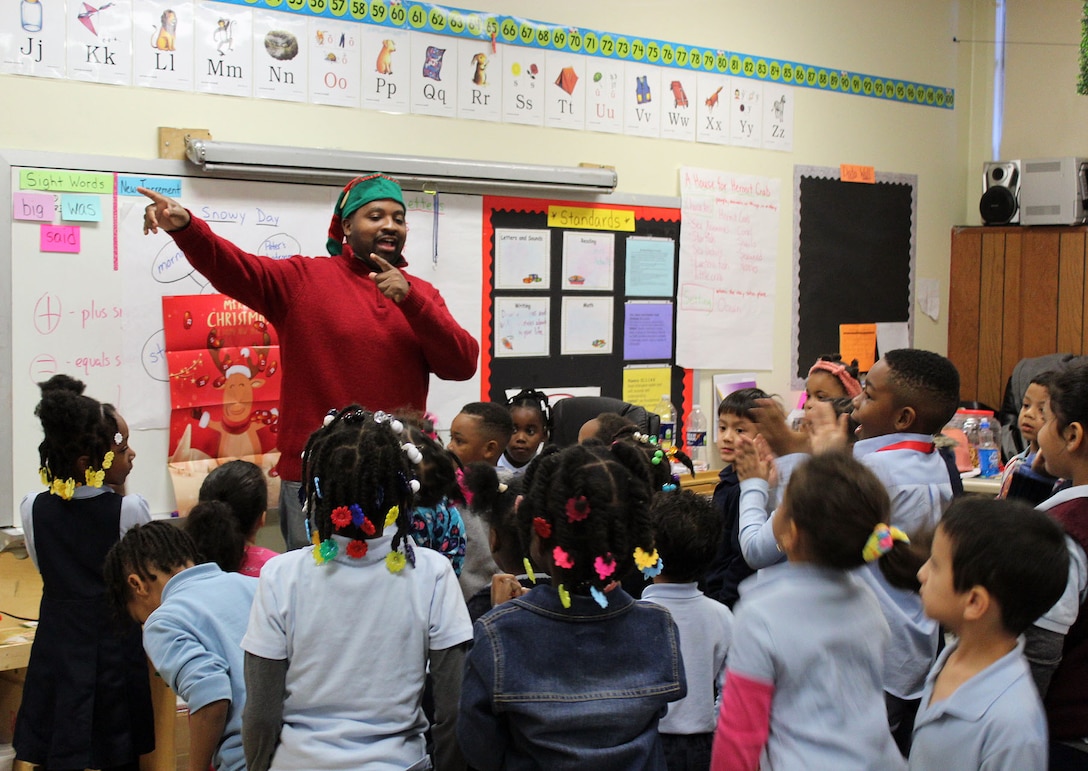 Ryan McLeod, a DLA Troop Support volunteer, plays games with kindergarten and first-grade students during the Troop Support Children’s Holiday Party Dec. 12, 2019 in Philadelphia.