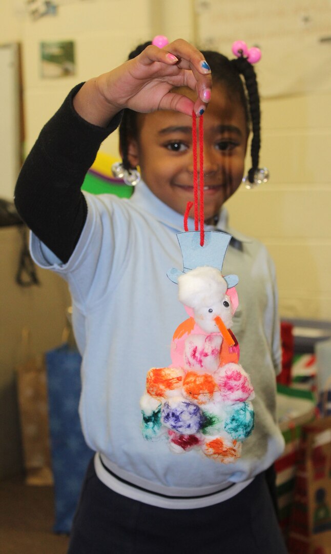 A student shows an ornament that was made during the DLA Troop Support Children’s Holiday Party Dec. 12, 2019 in Philadelphia.
