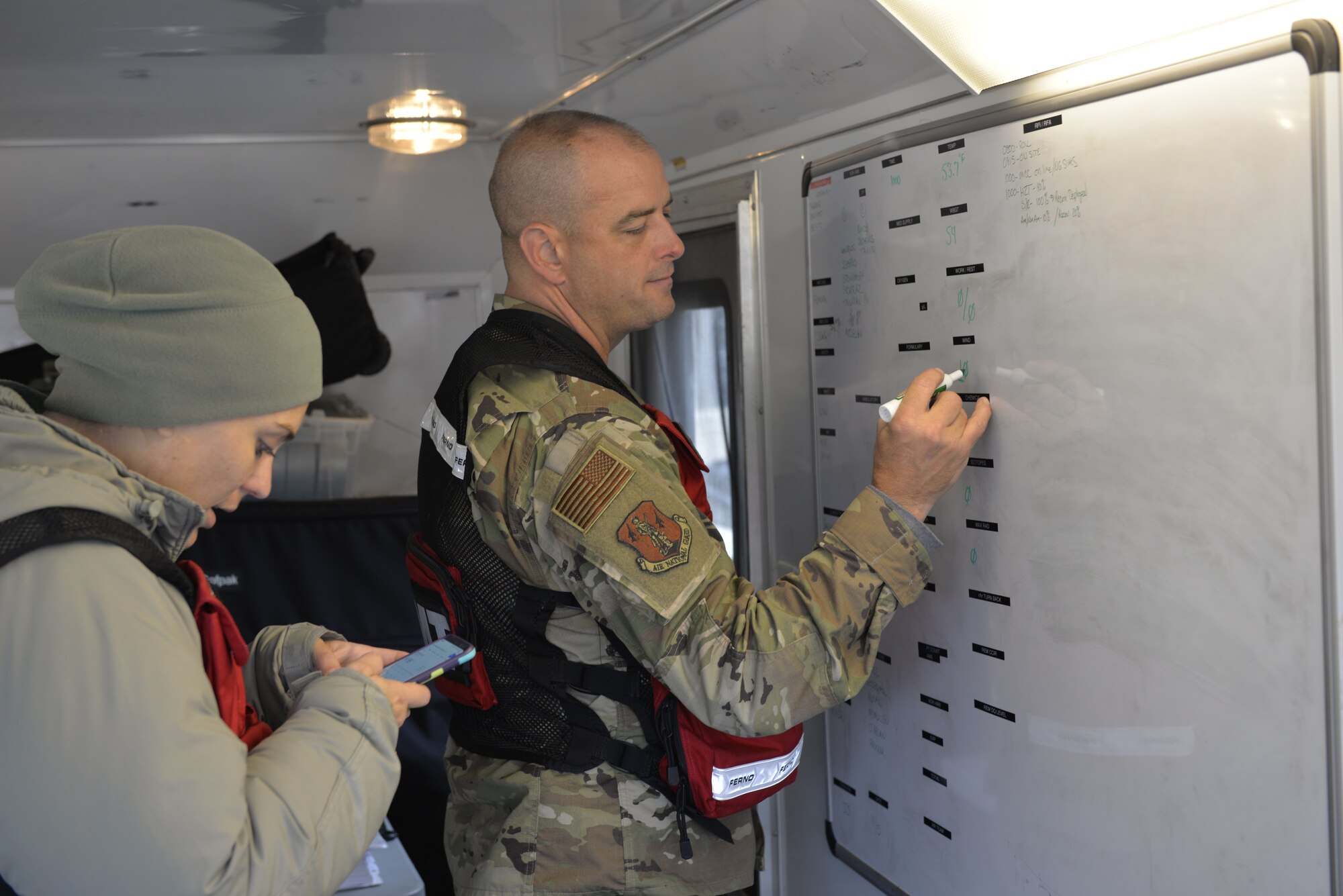 Airman 1st Class Jaylin Acres and Chief Master Sgt. Shawn Therberge, 157th Medical Group, Detachment 1, N.H. Air National Guard, gather data for work rest cycles, including food water temperature during a New England CERFP training exercise, Nov. 5, 2019, Brunswick, Maine. The week-long exercise enable the guardsmen to hone their medical response skills. (U.S. Air National Guard photo by Tech. Sgt. Aaron Vezeau)