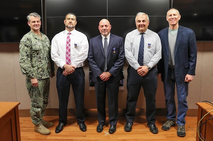 Human Resources Director Bill Shea, Systems Engineering Department Head Mike Thornton and retired Mechanical Engineer Gregory Harris received Department of the Navy Meritorious Civilian Service Awards from NSWC IHEODTD Commanding Officer Capt. Scott Kraft and Technical Director Ashley Johnson. Not pictured: Chemical, Biological and Radiological Defense Division Principal Engineer Bruce Corso. (U.S. Navy photo by Matt Poynor)