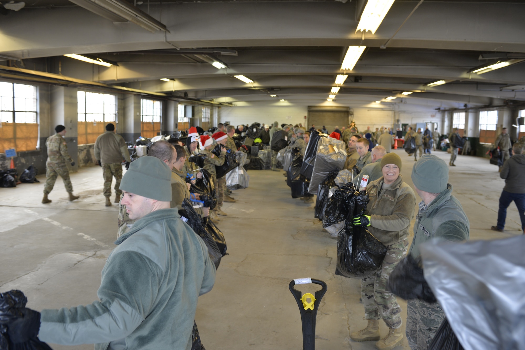 N.H. National Guardsmen help load donated Christmas gifts as part of Operation Santa Claus on Dec. 16 in Concord. Volunteers from the State Employees' Association, SEIU Local 1984, partner with N.H. guardsmen annually to transport presents to distribution points throughout the state. The program has been led by the SEA since 1960, and ensures gifts are provided to thousands of NH children in need. (U.S. Air National Guard photo by Tech. Sgt. Aaron Vezeau)