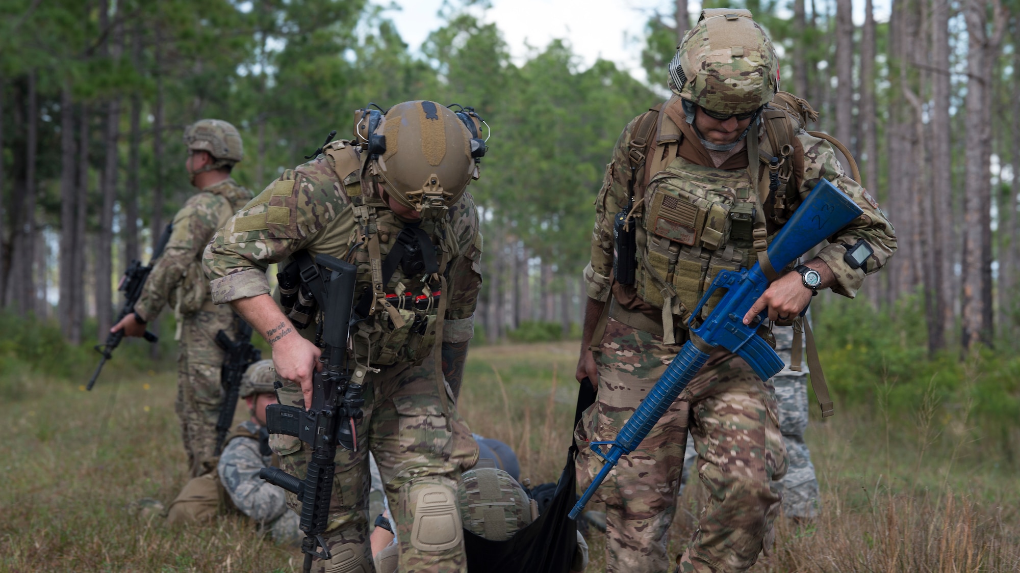 U.S. Air Force Staff Sgt. Taylor Lahteine, a 6th Civil Engineer Squadron explosive ordnance disposal (EOD) flight technician, and Staff Sgt. Ronnie Perez, a 927th Aeromedical Staging Squadron aeromedical technician, pull a simulated casualty to safety during a field training exercise Dec. 11, 2019, at Avon Park Air Force Range, Fla.  Lahteine and Perez provided tactical combat casualty care, such as tourniquet application, wound dressing and administering intravenous fluids during a simulated threat.