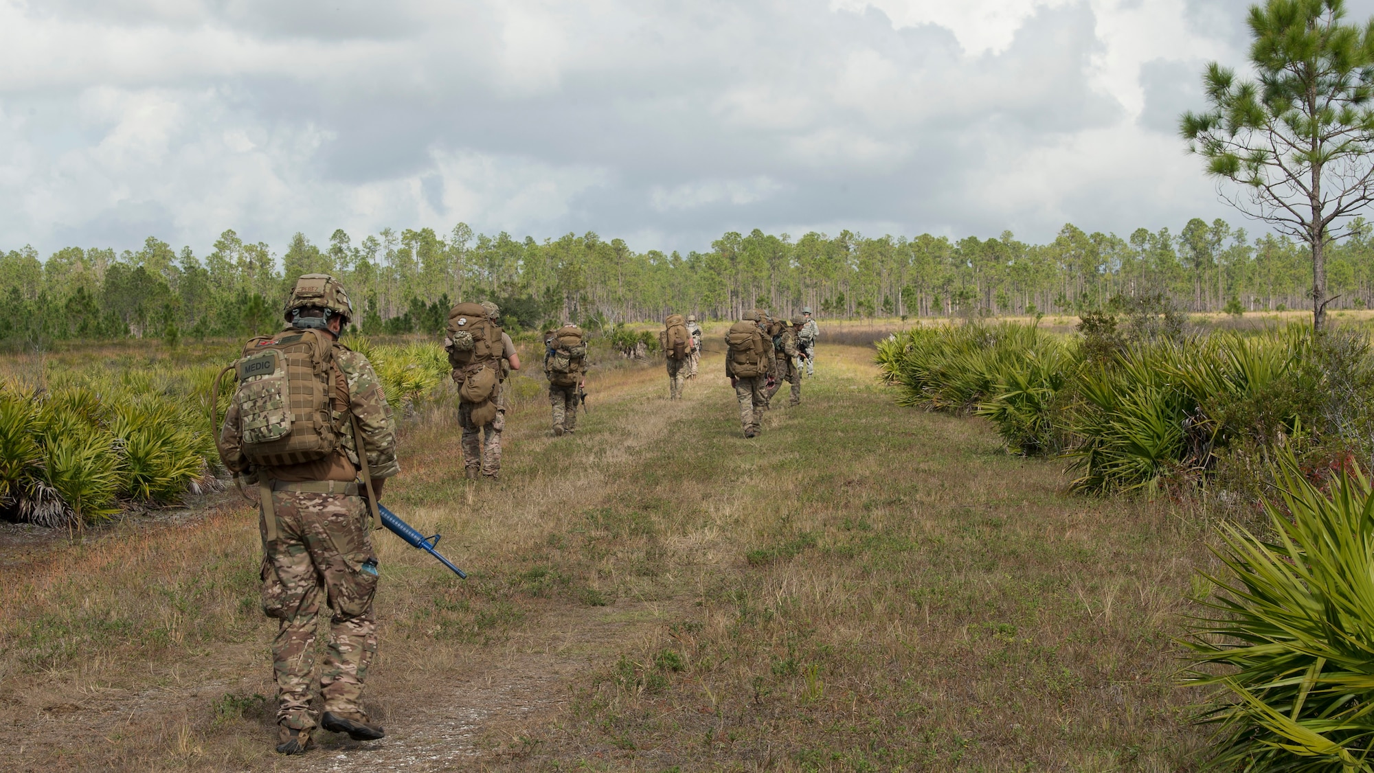 U.S. Air Force Airmen from the 6th Civil Engineer Squadron explosive ordnance disposal flight, the 6th Security Forces Squadron and the 927th Aeromedical Staging Squadron ruck march through Avon Park Air Force Range, Fla., Dec. 11, 2019.  The Airmen carried rucksacks weighing 35 to 50 pounds during a field training exercise to simulate real-world deployment operations.