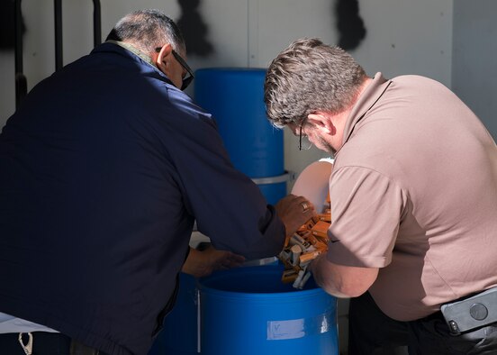 Carl Moser, 56th Civil Engineer Squadron environmental program manager (right), prepares used alkaline batteries for shipment Dec. 16, 2019, at Luke Air Force Base, Ariz.