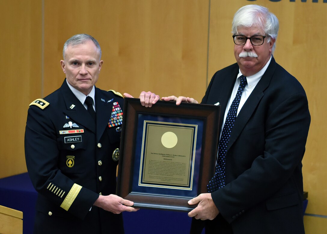 DIA Director Lt. Gen. Robert Ashley Jr. presents Phil Kosmacki, with the Melissa A. Drisko Collaborative Achievement Award, in honor of his late wife and former DIA Deputy Director Melissa Drisko