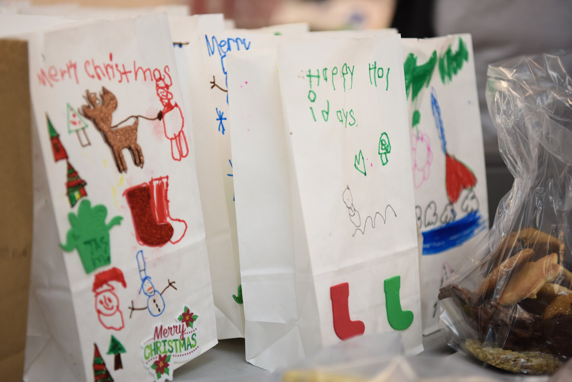 Bags decorated by students from local schools are used during the 2019 Cookie Drive Dec. 16, 2019, at Vandenberg Air Force Base, Calif. The Cookie Drive is an annual event held by the Spouse’s Club at VAFB, where they deliver cookies to Airmen across the base.  (U.S. Air Force photo by Airman 1st Class Hanah Abercrombie)