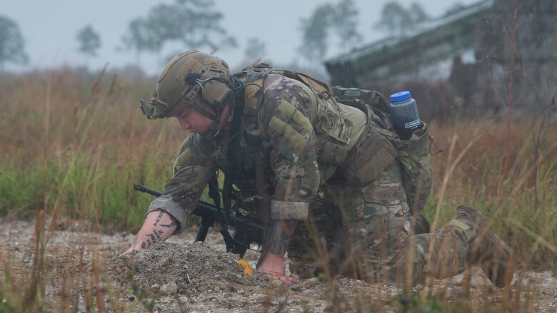 U.S. Air Force Staff Sgt. Taylor Lahteine, a 6th Civil Engineer Squadron explosive ordnance disposal (EOD) flight technician, works to secure a simulated explosive device during a field training exercise, Dec. 11, 2019, at Avon Park Air Force Range, Fla.  The MacDill EOD flight conducted training simulations for detecting and securing improvised explosive devices to prepare for real-world deployment operations.