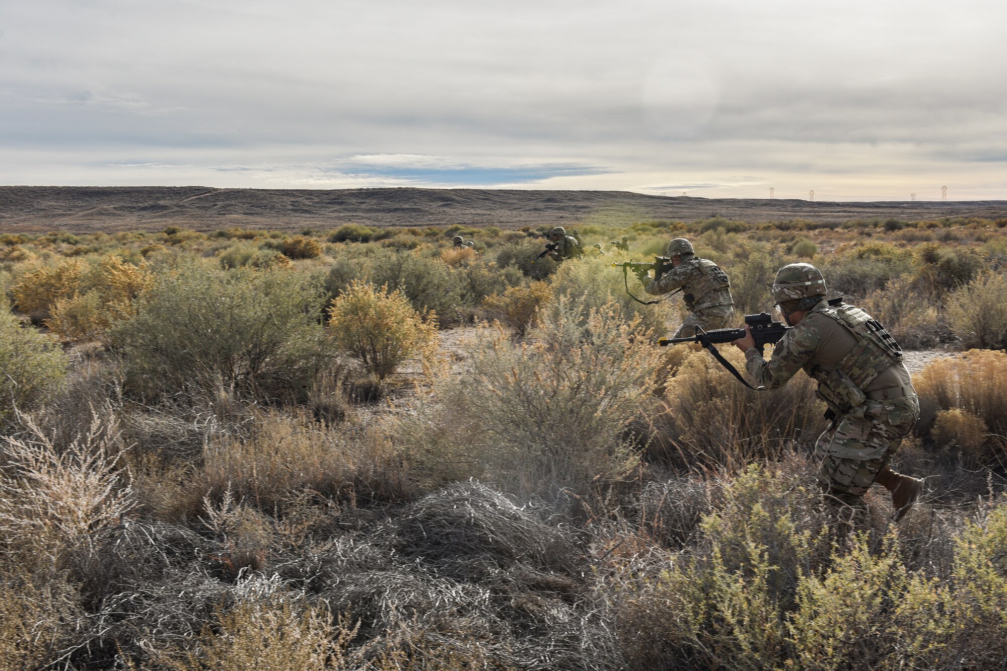 Security forces members advanced towards opposing forces during training.
