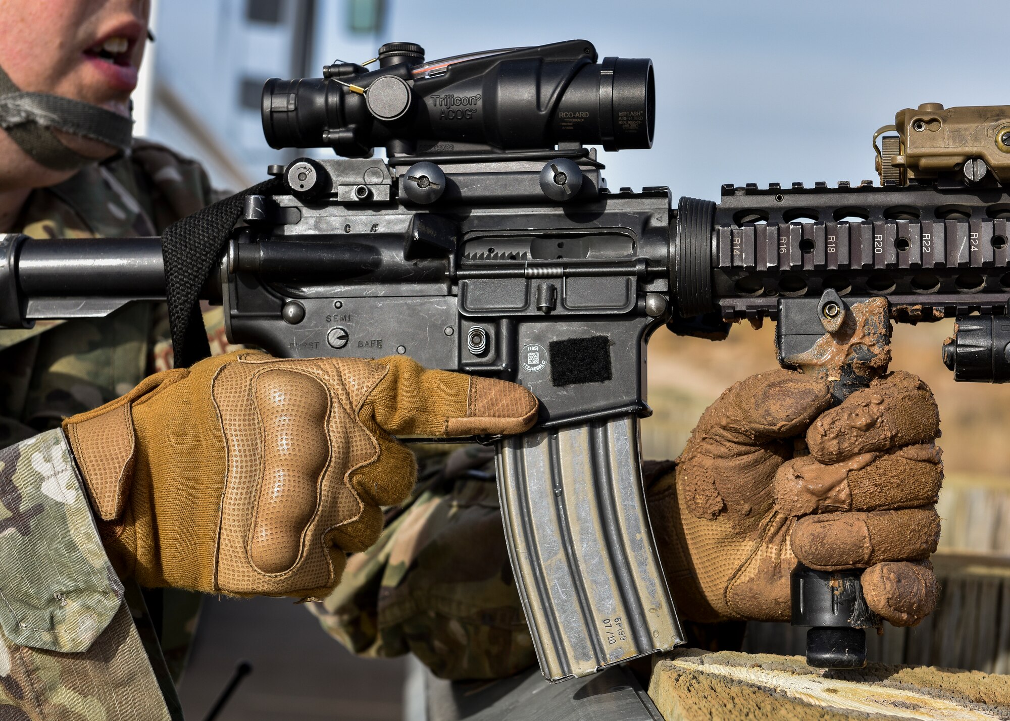 A security forces member holds his weapon.