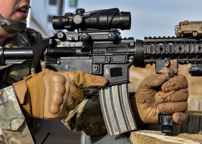 A security forces member holds his weapon.
