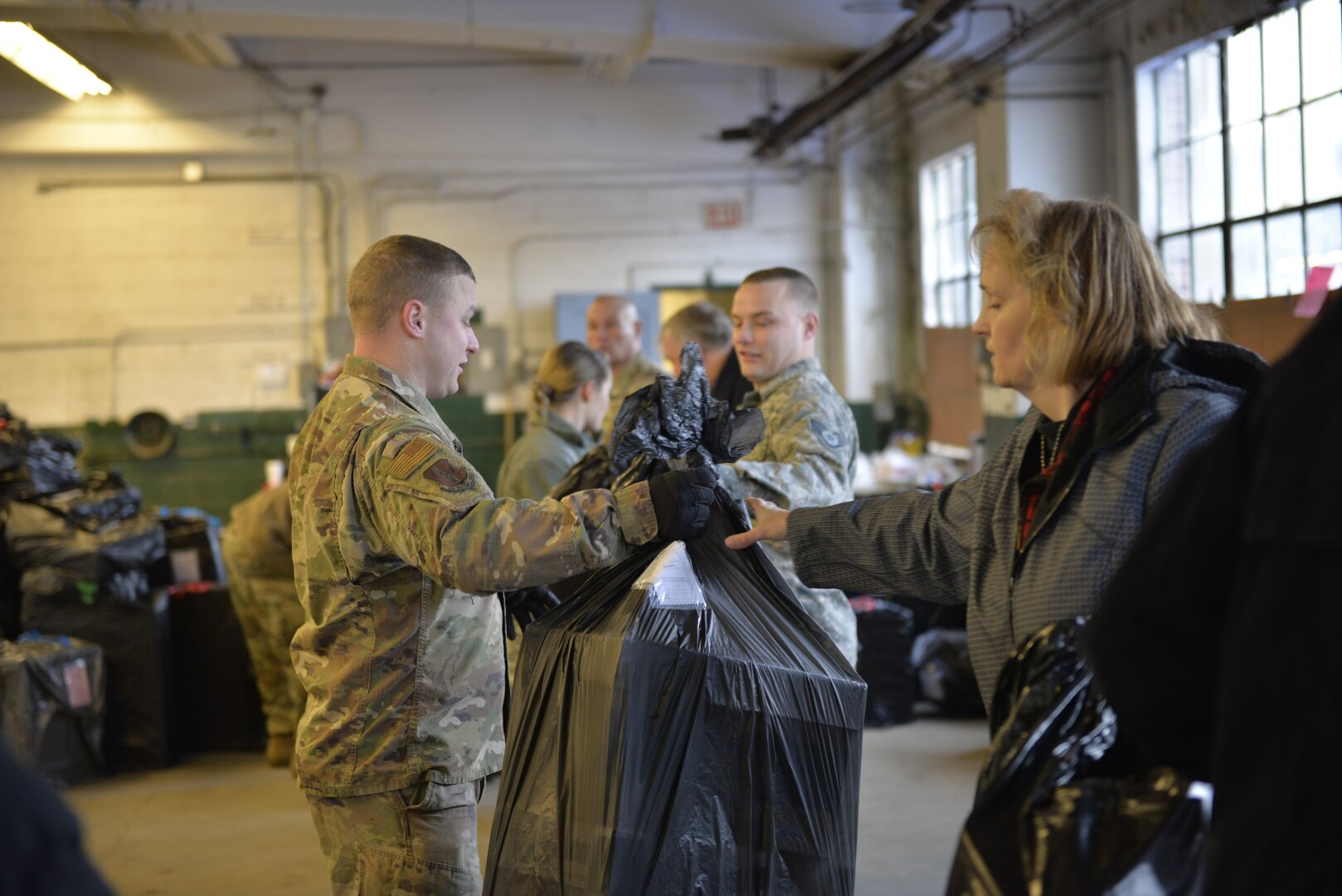 Brothers Tech. Sgt. Sean Wood and Staff Sgt. Christopher Wood, with the N.H. Air National Guard, help load donated Christmas gifts as part of Operation Santa Claus on Dec. 16 in Concord. Volunteers from the State Employees' Association, SEIU Local 1984, partner with N.H. guardsmen annually to transport presents to distribution points throughout the state. The program has been led by the SEA since 1960, and ensures gifts are provided to thousands of NH children in need. (U.S. Air National Guard photo by Tech. Sgt. Aaron Vezeau)