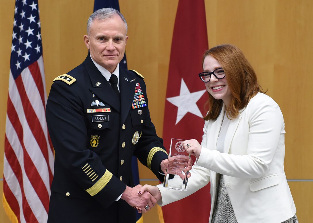 Amy Levine, analyst for DCTC, poses with Lt. Gen. Robert Ashley Jr. as she accepts the DIA Award for Meritorious Civilian Service