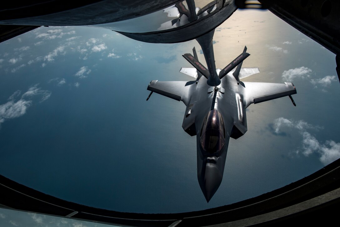 A U.S. Air Force KC-135 Stratotanker boom operator with the 28th Expeditionary Air Refueling Squadron conducts an aerial refueling, giving gas to a U.S. Air Force F-35A Lightning II assigned to the 34th Expeditionary Fighter Squadron above the Arabian Gulf, Dec. 3, 2019. T