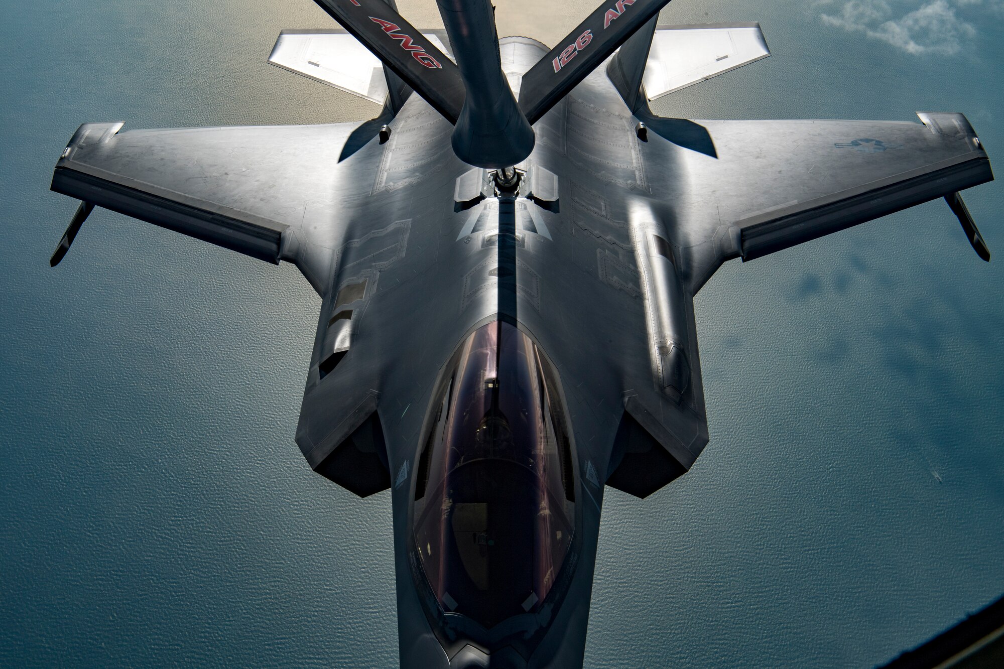 A U.S. Air Force KC-135 Stratotanker boom operator with the 28th Expeditionary Air Refueling Squadron conducts an aerial refueling to a U.S. Air Force F-35A Lightning II assigned to the 34th Expeditionary Fighter Squadron above the Arabian Gulf, Dec. 3, 2019.