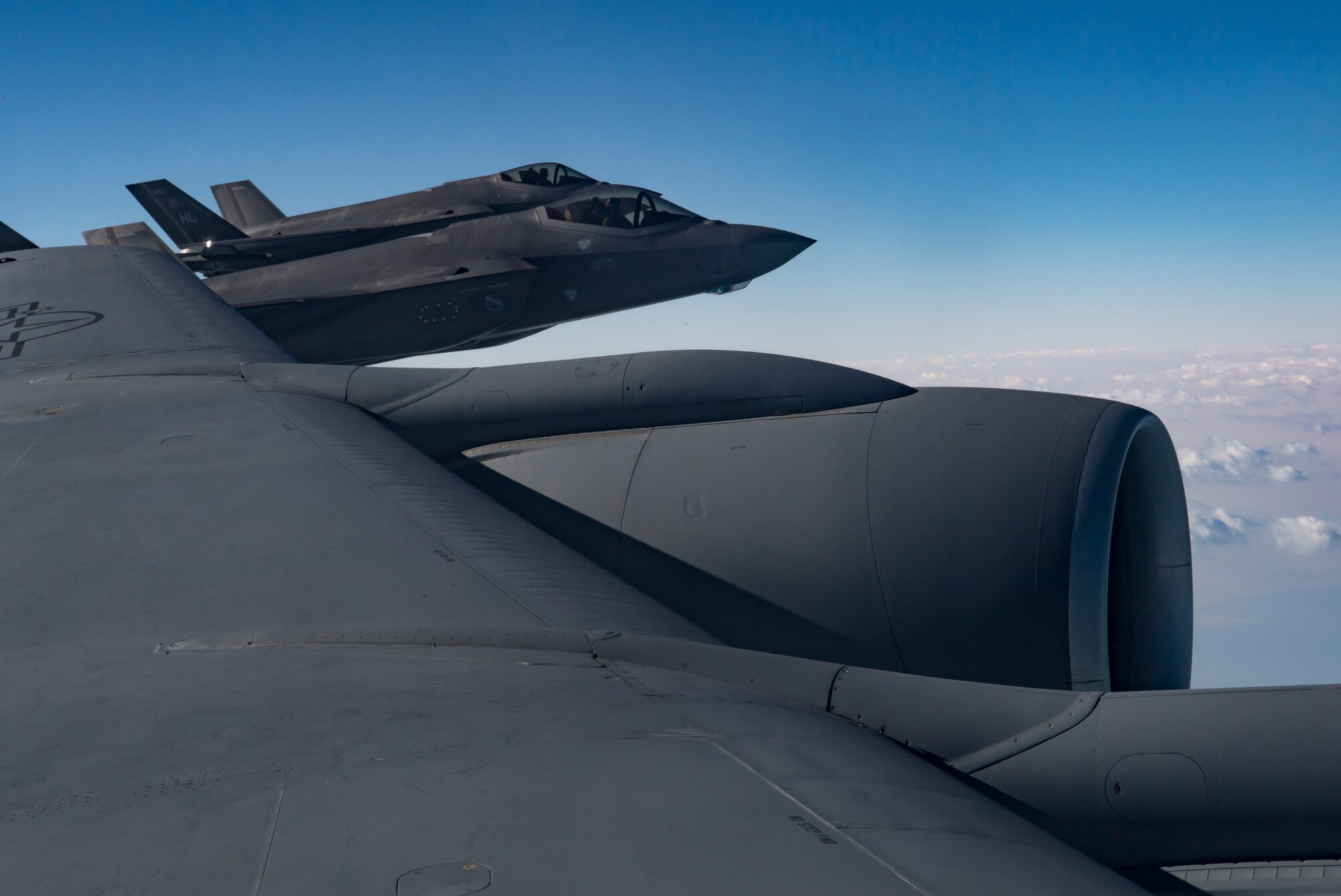 Two U.S. Air Force F-35A Lightning IIs assigned to the 34th Expeditionary Fighter Squadron fly beside a U.S. Air Force KC-135 Stratotanker assigned to the 28th Expeditionary Air Refueling Squadron above the Arabian Gulf, Dec. 3, 2019.