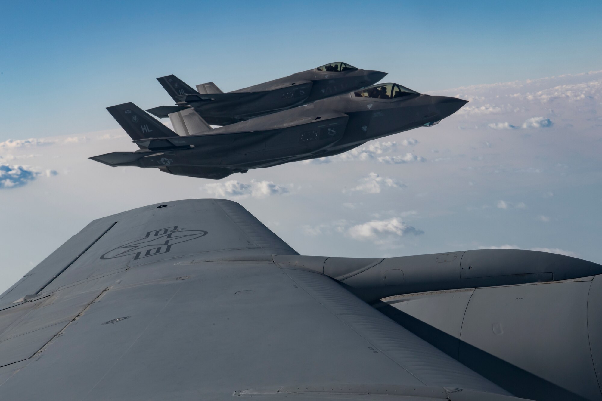 Two U.S. Air Force F-35A Lightning IIs assigned to the 34th Expeditionary Fighter Squadron fly beside a U.S. Air Force KC-135 Stratotanker assigned to the 28th Expeditionary Air Refueling Squadron above the Arabian Gulf, Dec. 3, 2019.