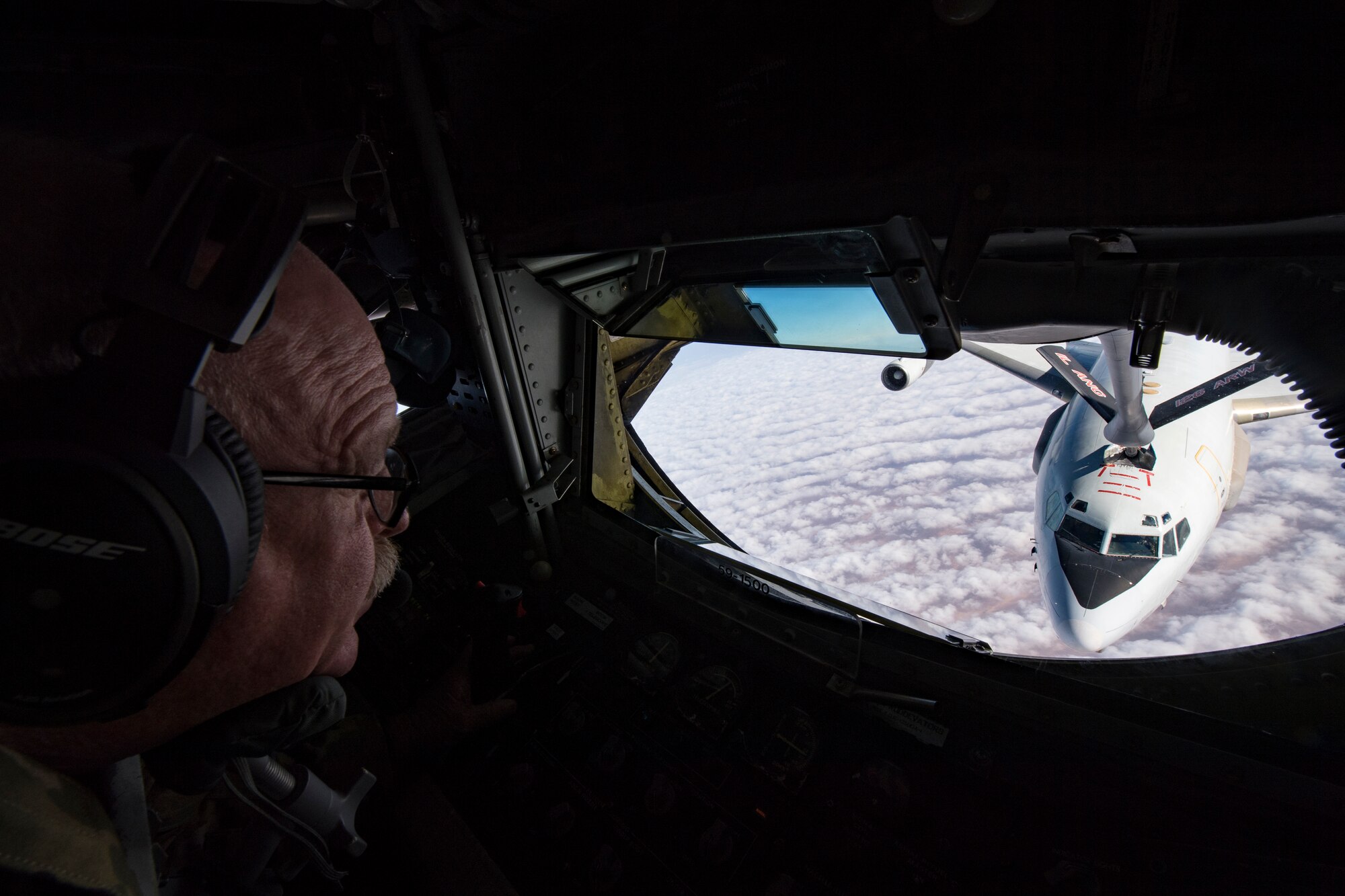 A U.S. Air Force KC-135 Stratotanker boom operator with the 28th Expeditionary Air Refueling Squadron conducts an aerial refueling to a U.S. Air Force E-3 Sentry assigned to the 968th Expeditionary Airborne Air Control Squadron above the Arabian Gulf, Dec. 3, 2019.