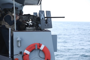 Boatswain’s Mate 2nd Class Garner Jordan aims a M2 .50 Caliber machine gun at simulated enemy boats during Griffin Missile Exercise 19. The exercise demonstrated a proven capability for the ships to defend themselves against small boat threats and ensure maritime security through key chokepoints in the U.S. Central Command area of responsibility.