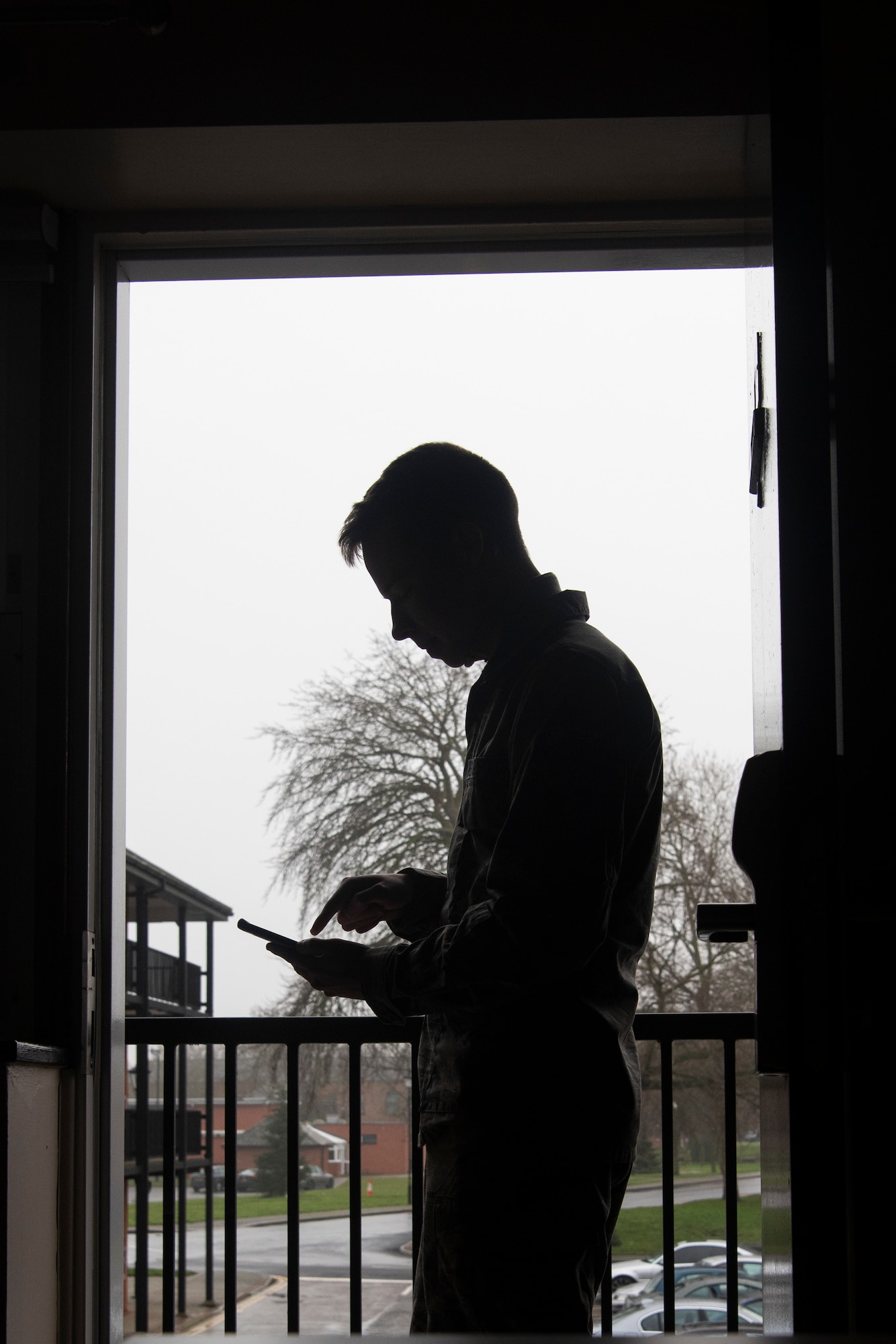 Airman Drake Koenig-Frederickson, 100th Aircraft Maintenance Squadron aerospace propulsion apprentice, submits a work order from his dorm room using the RAF Mildenhall Dormitory app at RAF Mildenhall, England, Dec. 17, 2019. Airmen were previously required to visit the Unaccompanied Housing Office to submit work orders, but they can now request maintenance on their room from a cell phone. (U.S. Air Force photo by Airman 1st Class Joseph Barron)