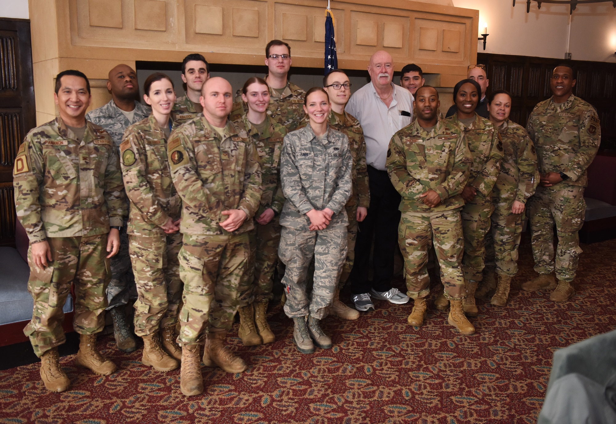 William “Doc” Schmitz, Commander-in-Chief for Veterans of Foreign Wars, poses for a photo with Team Mildenhall Airmen during a visit to RAF Mildenhall, England, Dec. 18, 2019. During his visit, Schmitz toured base facilities and spoke to Airmen about their mission. (U.S. Air Force photo by Senior Airman Brandon Esau)