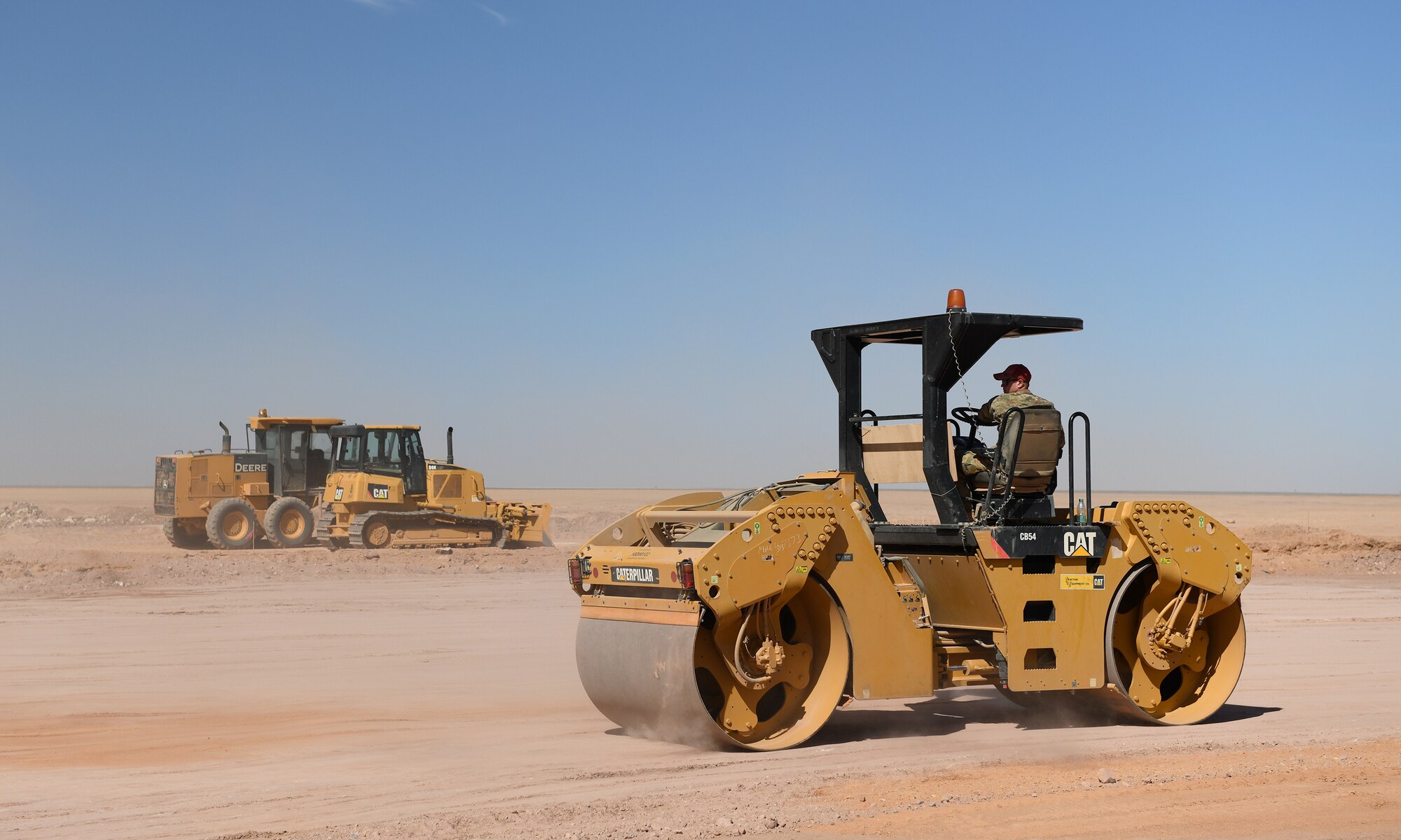 A U.S. Airman deployed with the 819th Expeditionary Rapid Engineer Deployable Heavy Operational Repair Squadron Engineer team uses a tandem vibratory roller to densify the earth at Nigerien Air Base 201, Niger, Dec. 13, 2019. In Niger, deployed RED HORSE teams are continually improving base infrastructure and building new facilities for current and future missions. (U.S. Air Force photo by Staff Sgt. Alex Fox Echols III)