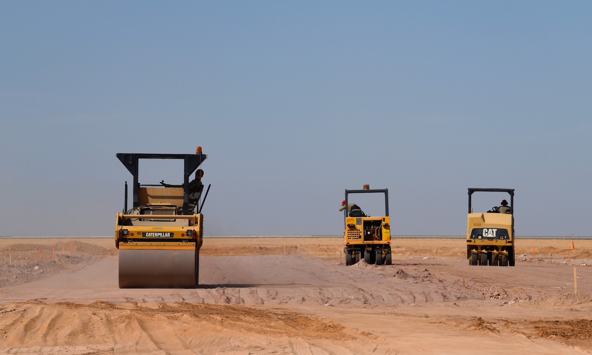 U.S. Airmen deployed with the 819th Expeditionary Rapid Engineer Deployable Heavy Operational Repair Squadron Engineer team use a tandem vibratory roller and compactors to densify the earth at Nigerien Air Base 201, Niger, Dec. 13, 2019. In Niger, deployed RED HORSE teams are continually improving base infrastructure and building new facilities for current and future missions. (U.S. Air Force photo by Staff Sgt. Alex Fox Echols III)