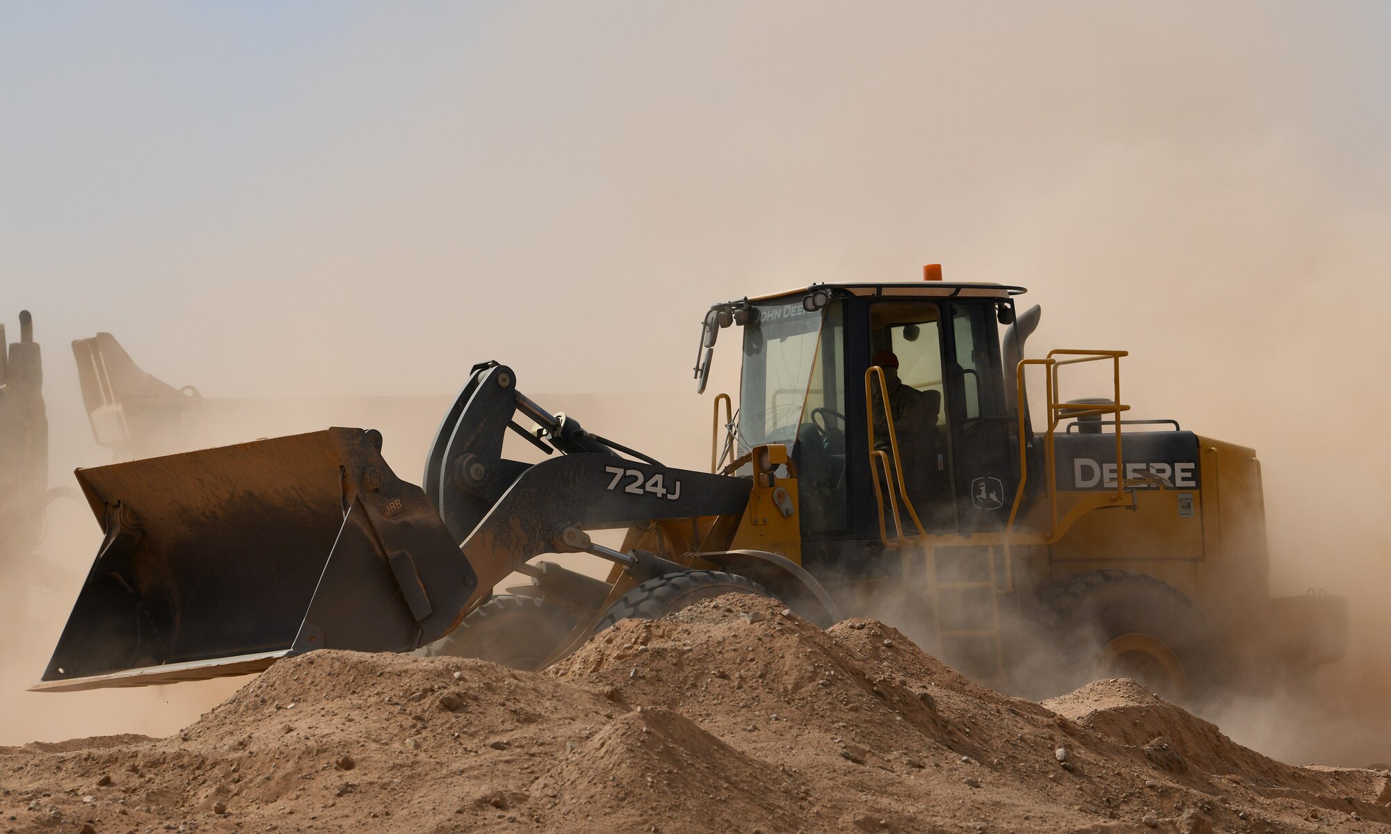 A U.S. Airman deployed with the 819th Expeditionary Rapid Engineer Deployable Heavy Operational Repair Squadron Engineer team moves earth using a wheel loader at Nigerien Air Base 201, Niger, Dec. 13, 2019. In Niger, deployed RED HORSE teams are continually improving base infrastructure and building new facilities for current and future missions. (U.S. Air Force photo by Staff Sgt. Alex Fox Echols III)