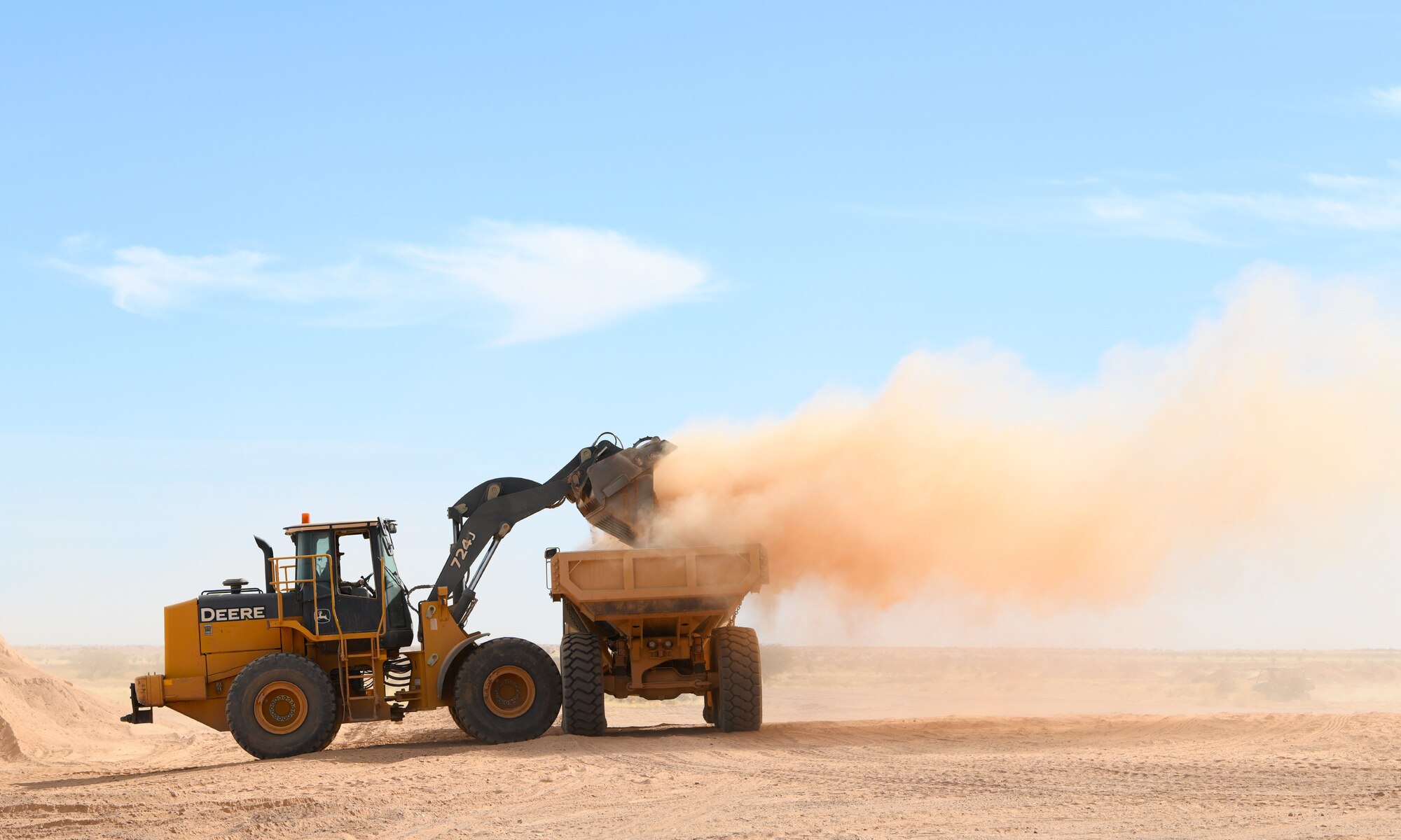 A U.S. Airman deployed with the 819th Expeditionary Rapid Engineer Deployable Heavy Operational Repair Squadron Engineer team uses a wheel loader to move dirt into a dump truck at Nigerien Air Base 201, Niger, Dec. 13, 2019. In Niger, deployed RED HORSE teams are continually improving base infrastructure and building new facilities for current and future missions. (U.S. Air Force photo by Staff Sgt. Alex Fox Echols III)