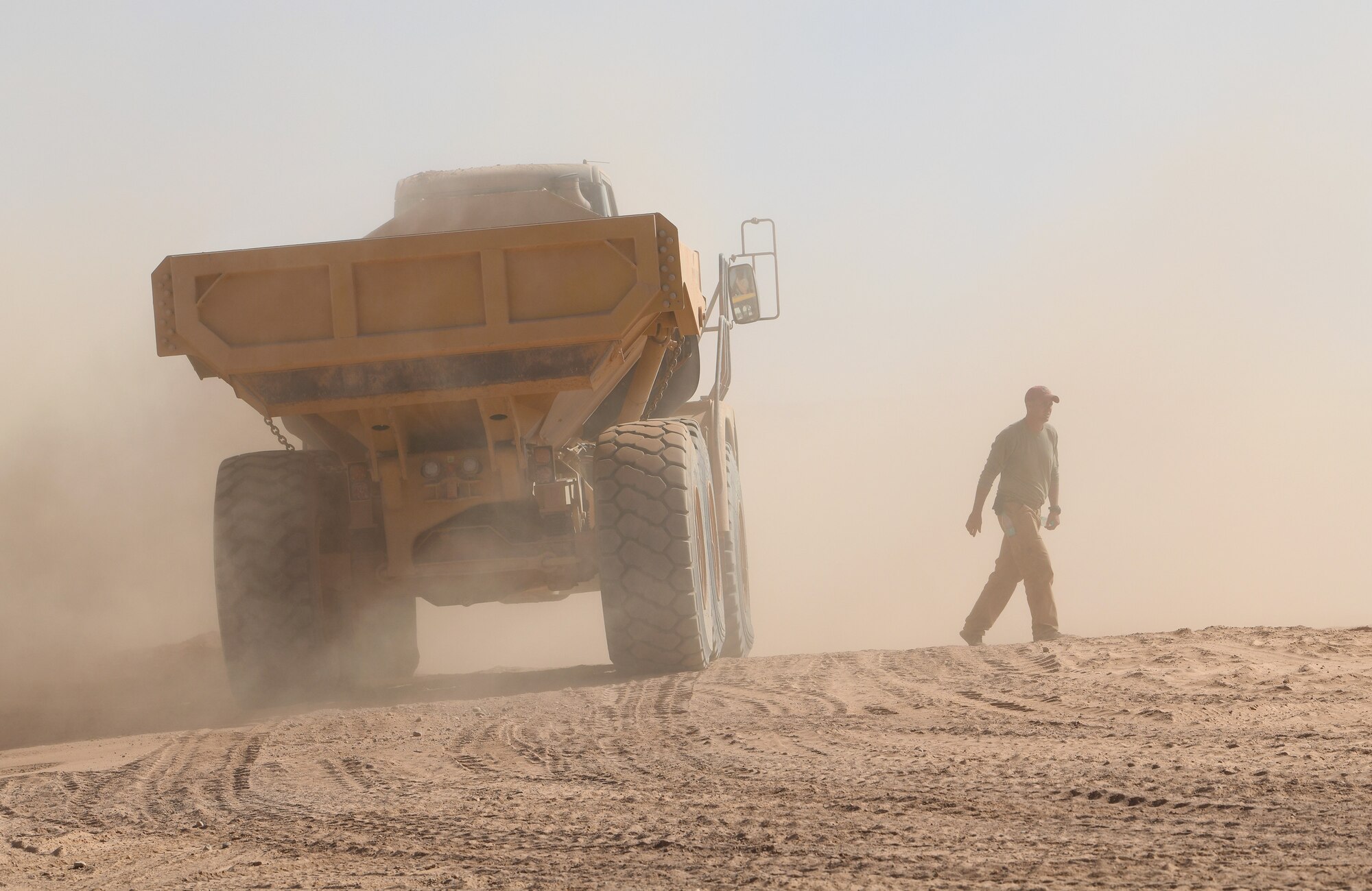 A U.S. Airman deployed with the 819th Expeditionary Rapid Engineer Deployable Heavy Operational Repair Squadron Engineer team walks away from a dump truck at Nigerien Air Base 201, Niger, Dec. 13, 2019. In Niger, deployed RED HORSE teams are continually improving base infrastructure and building new facilities for current and future missions. (U.S. Air Force photo by Staff Sgt. Alex Fox Echols III)