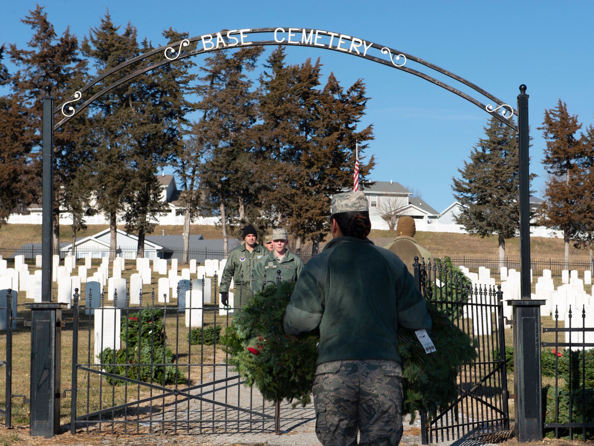 A photo of a volunteer carrying wreaths at at Offutt Air Force Base.