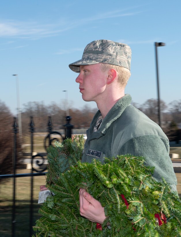 A photo of a volunteer carrying wreaths at at Offutt Air Force Base.