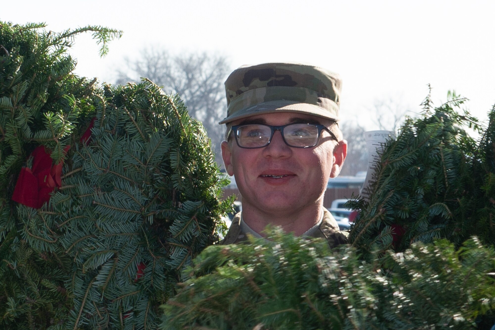 A photo of A volunteer carrying wreaths at at Offutt Air Force Base.