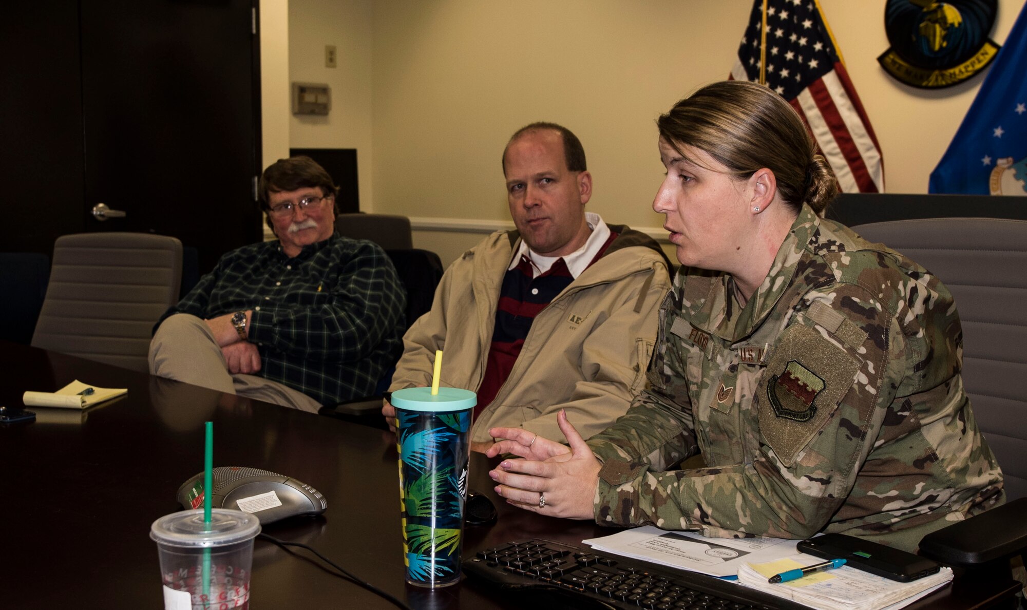 A photo of people speaking at a table