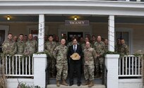 Officers and senior non-commissioned officers assigned to the New York Army National Guard's 42nd Infantry Division gather on the porch of the Central House Hotel in Germantown, N.Y., following a professional development lecture on Middle Eastern history by Bard College professor Sean McMeekin (center) Dec.13, 2019. McMeekin was asked to speak so the leaders could better understand the history of the region before the division deploys to Kuwait in 2020. The session was held in the hotel to accommodate the professor's schedule.
