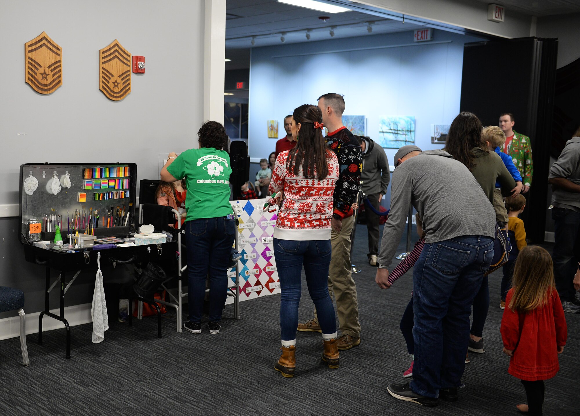 Families wait in line for face painting during Breakfast with Santa in the Columbus Club Dec. 14, 2019, on Columbus Air Force Base, Miss. A variety of options were available to choose from, including mermaid, ice princess, dragon, and so many more. (U.S. Air Force photo by Airman 1st Class Hannah Bean)