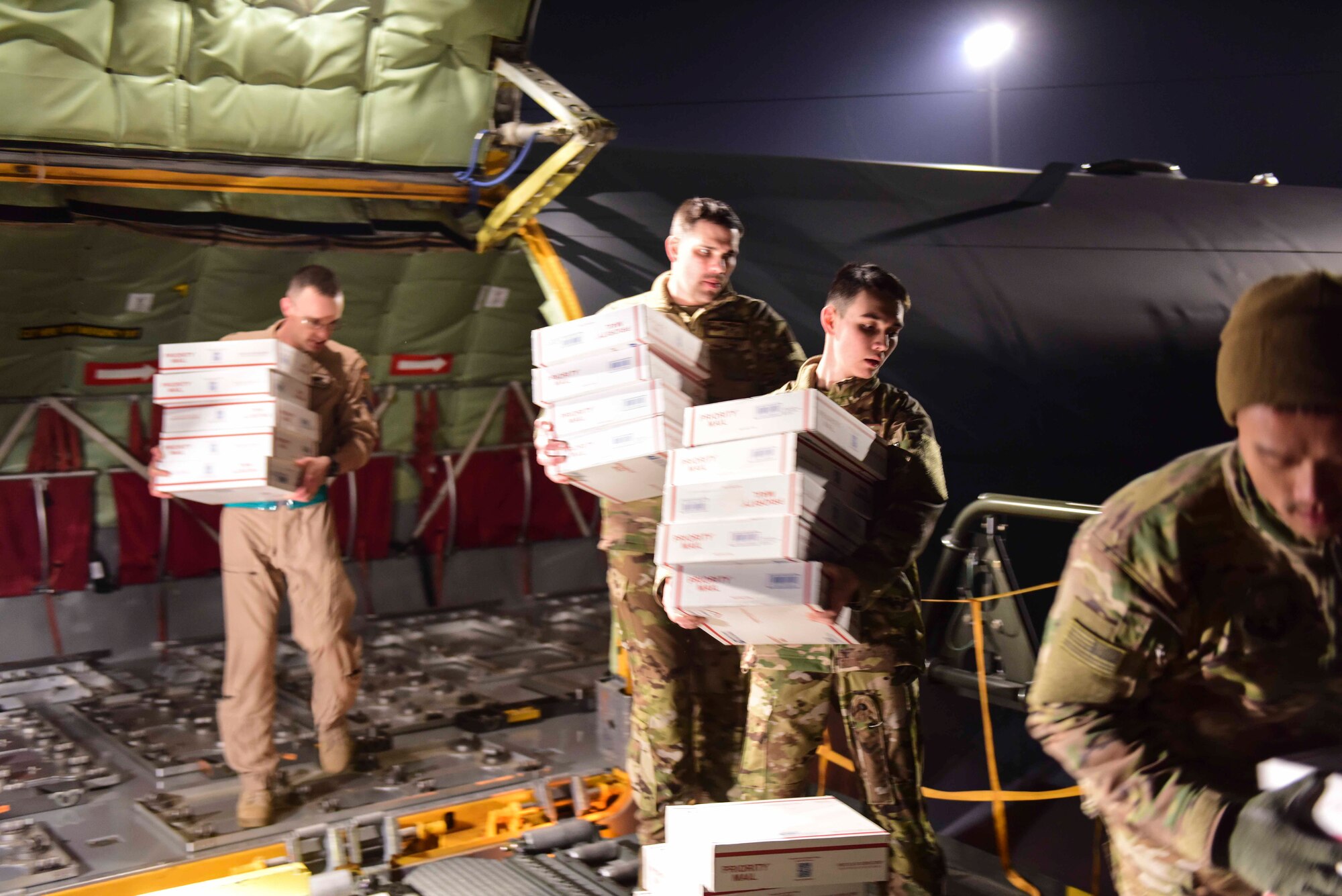 U.S. Air Force Airmen assigned to the 22nd Expeditionary Air Refueling Squadron unload care packages from a KC-135 Stratotanker Dec. 7, 2019, at Incirlik Air Base, Turkey. Care packages from Spokane, Washington, poured in for American personnel stationed at Incirlik. (U.S. Air Force photo by Senior Airman Trevor Gordnier)