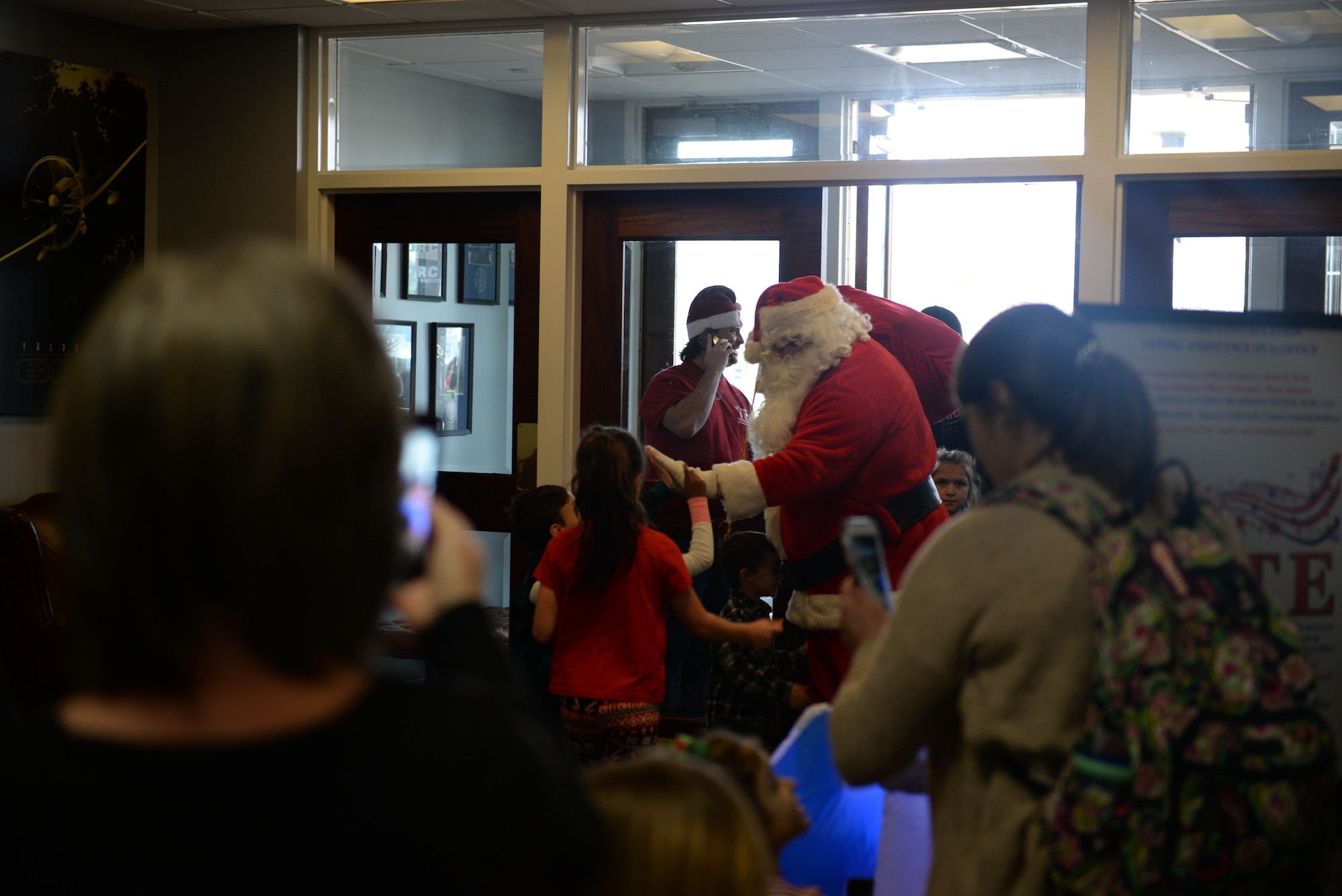 Children and family members welcome Santa Claus at the entrance of the Columbus Club during Breakfast with Santa, Dec. 14, 2019, on Columbus Air Force Base, Miss. Santa previously visited Columbus AFB Dec. 3 after he arrived on base in a T-1A Jayhawk to parade down to the tree lighting ceremony. (U.S. Air Force photo by Airman 1st Class Hannah Bean)