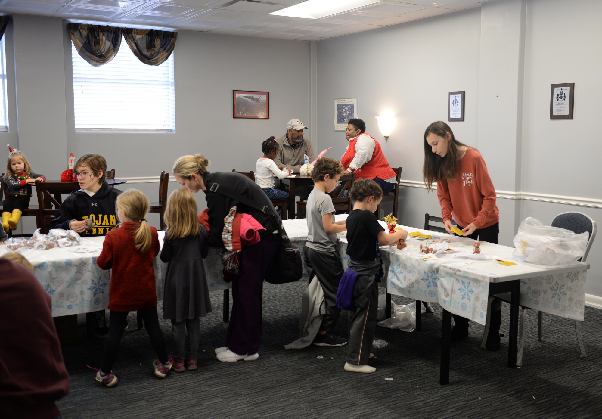 Children, families and friends decorate Christmas crafts during Breakfast with Santa in the Columbus Club Dec. 14, 2019, on Columbus Air Force Base, Miss. Children of all ages participated in a variety of events to include hand making crafts, playing games and so much more. (U.S. Air Force photo by Airman 1st Class Hannah Bean)