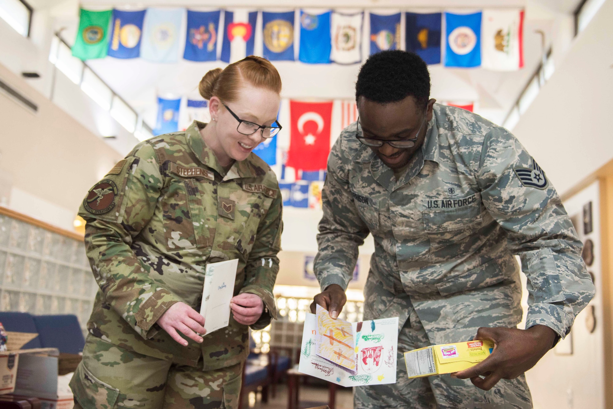Image of two Airmen reading holiday cards