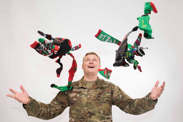 Photo of male Airman tossing socks
