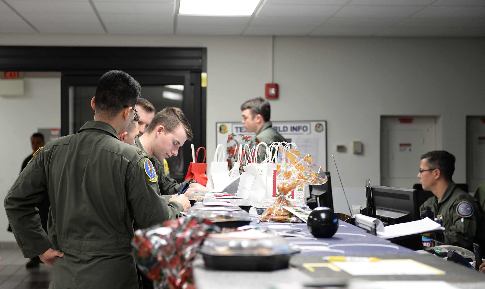 Bags and tins of cookies sit along the T-6 Texan II step desk during the Columbus Spouses Club Cookie Drive Dec. 17, 2019, on Columbus Air Force Base, Miss. Donations and other support were provided by Columbus community members and local businesses as well as base community members, providing nearly 700 dozen cookies to Airman. (U.S. Air Force photo by Airman 1st Class Hannah Bean)