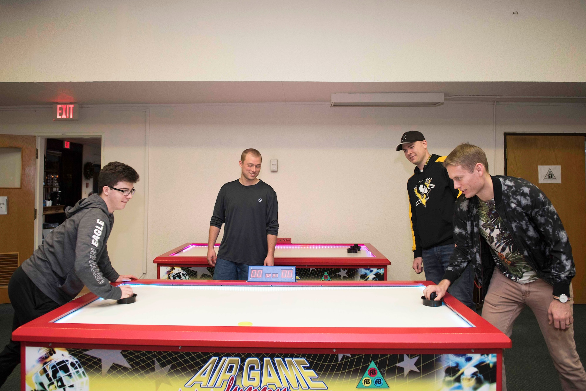 Photo of Airmen playing air hockey