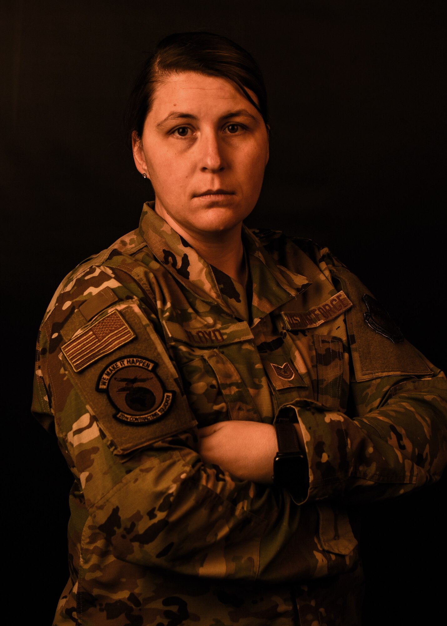 A photo of an Airman standing with arms crossed