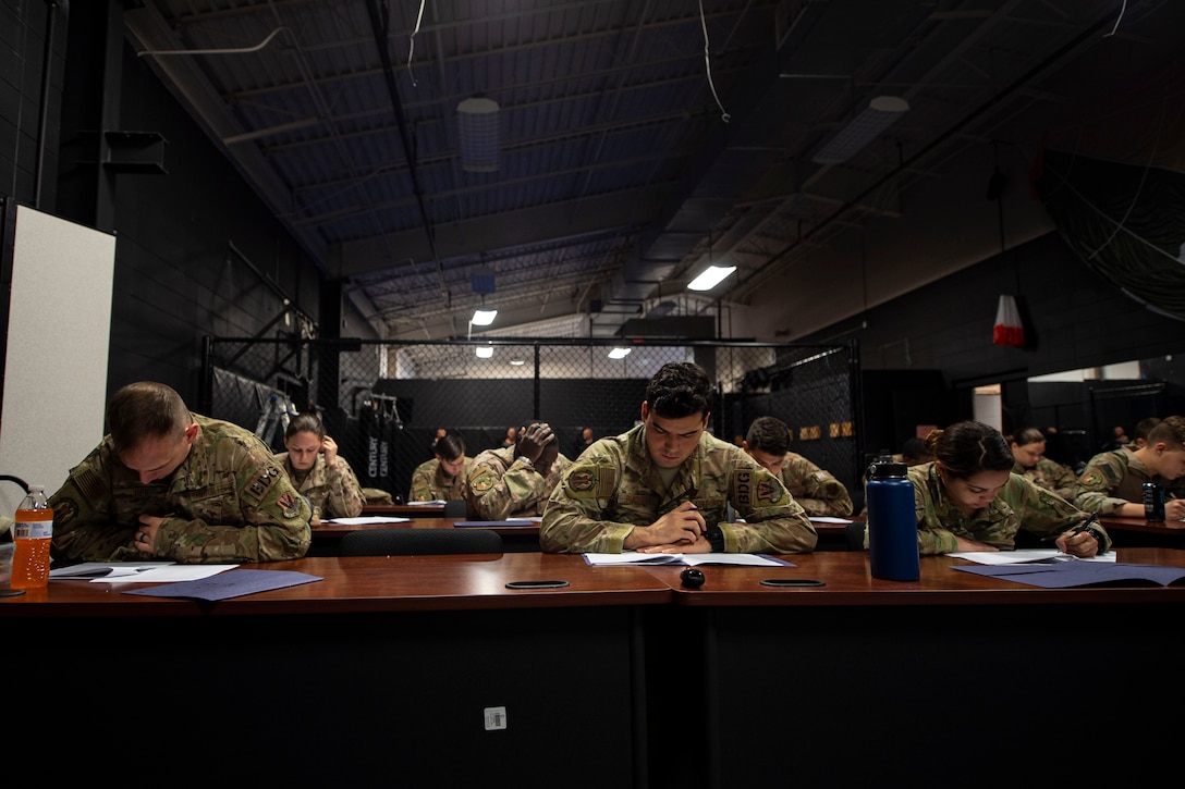 Photo of Airmen taking a test during the Combat Lifesavers Course.