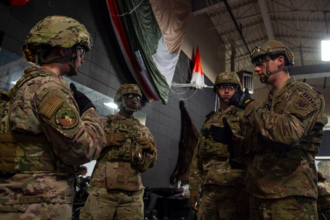 Photo of Airmen discuss strategy during the Combat Lifesavers Course.