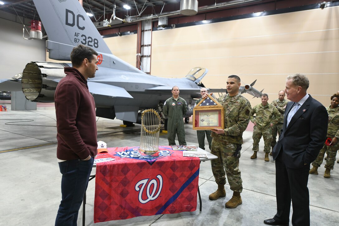 Ryan Zimmerman, Washington Nationals first baseman, is presented with a certificate and flag during a World Series trophy display event at Joint Base Andrews, Md., Dec. 17, 2019. The flag was flown over the nation’s capital in a District of Columbia Air National Guard F-16 Fighting Falcon, 113th Wing, who have provided flyovers for Washington Nationals games. (U.S. Air Force photo by Airman 1st Class Spencer Slocum)