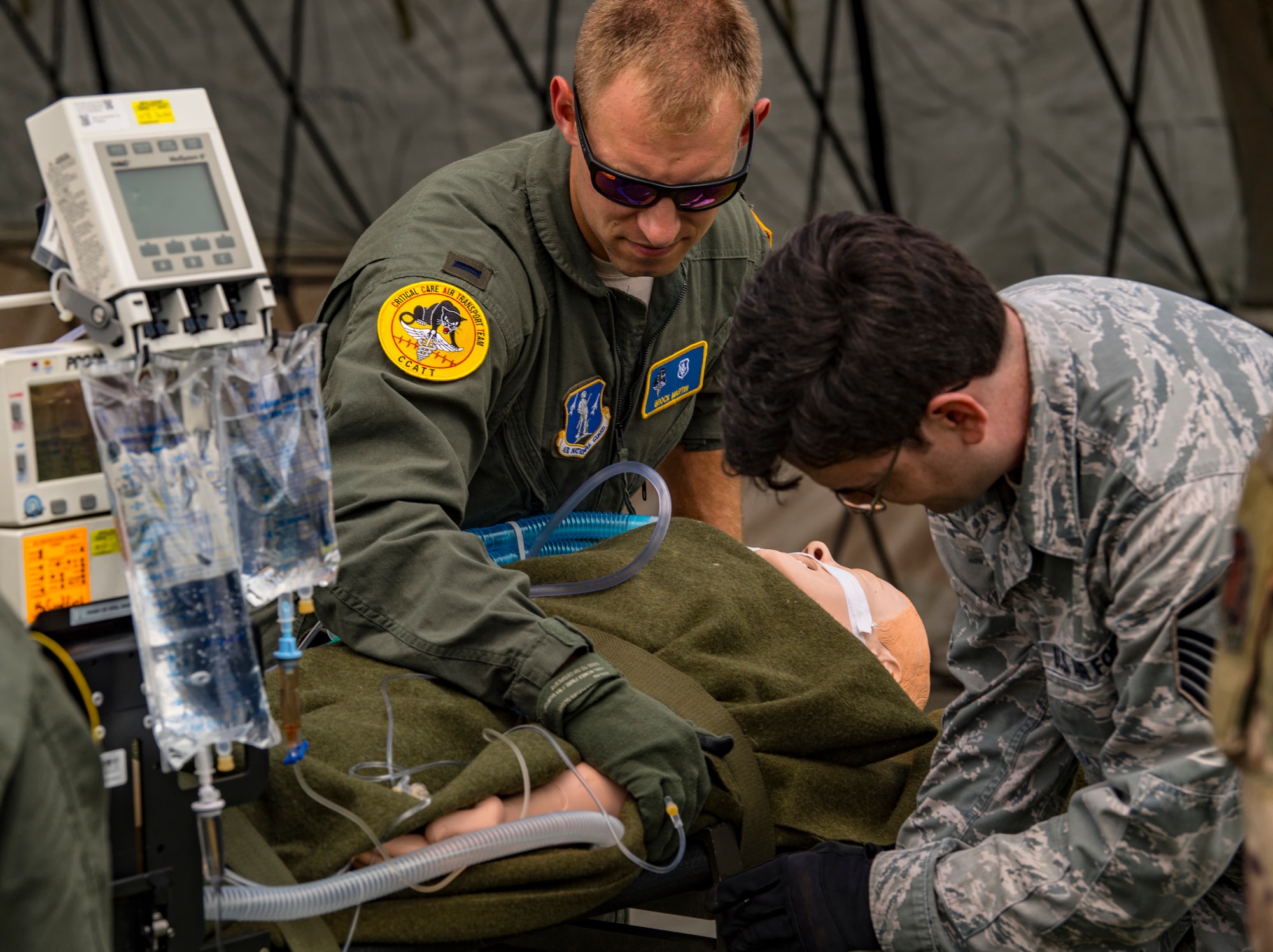 Airmen assigned to the 167th Medical Group, Martinsburg, West Virginia, secures a simulated patient during a casualty evacuation training for Sentry Storm 19 held July 20, 2019, at the Raleigh County Memorial Airport. Sentry Storm is a joint exercise held in southern West Virginia that offers military units real world training while providing domestic rapid response capabilities to support the World Scout Jamboree. (U.S. Air National Guard photo illustration by Master Sgt. De-Juan Haley)