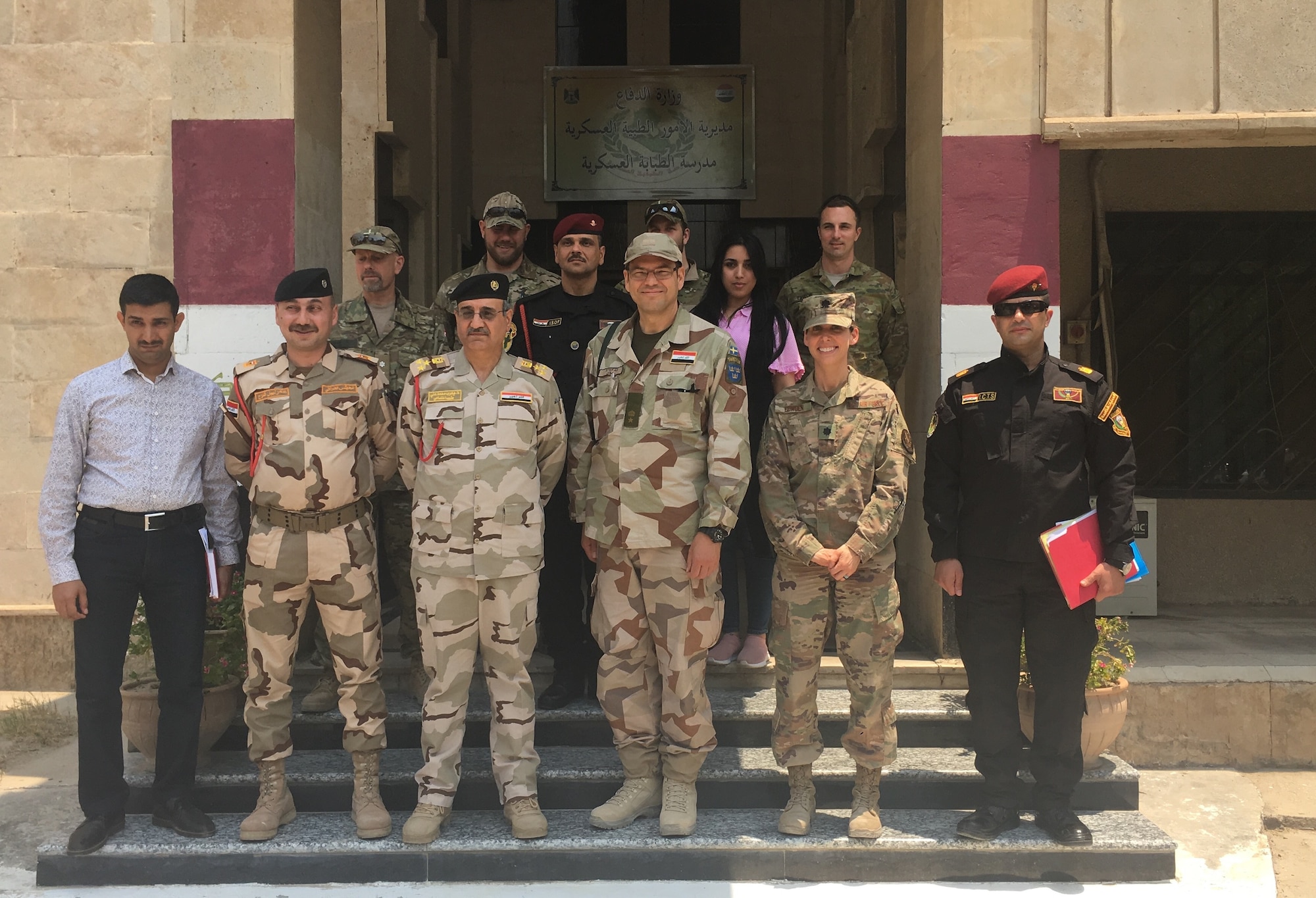 U.S. Air Force Lt. Col. Jessica Cowden, Infectious Disease Programs chief with the Defense Institute for Medical Operations, Joint Base San Antonio-Lackland, Texas, poses for a photo with the NATO Mission Iraq Embedded Training Team during the Combined Joint Task Force - Operation Inherent Resolve, June 25, 2019. The team, which included military members from Iraq, Australia, and Denmark, participated in a meeting to discuss standardized combat lifesaver training and standard equipment lists for training. Cowden deployed as an International Health Specialist, providing a foundation for improved medical security cooperation in Iraq. (Courtesy photo)