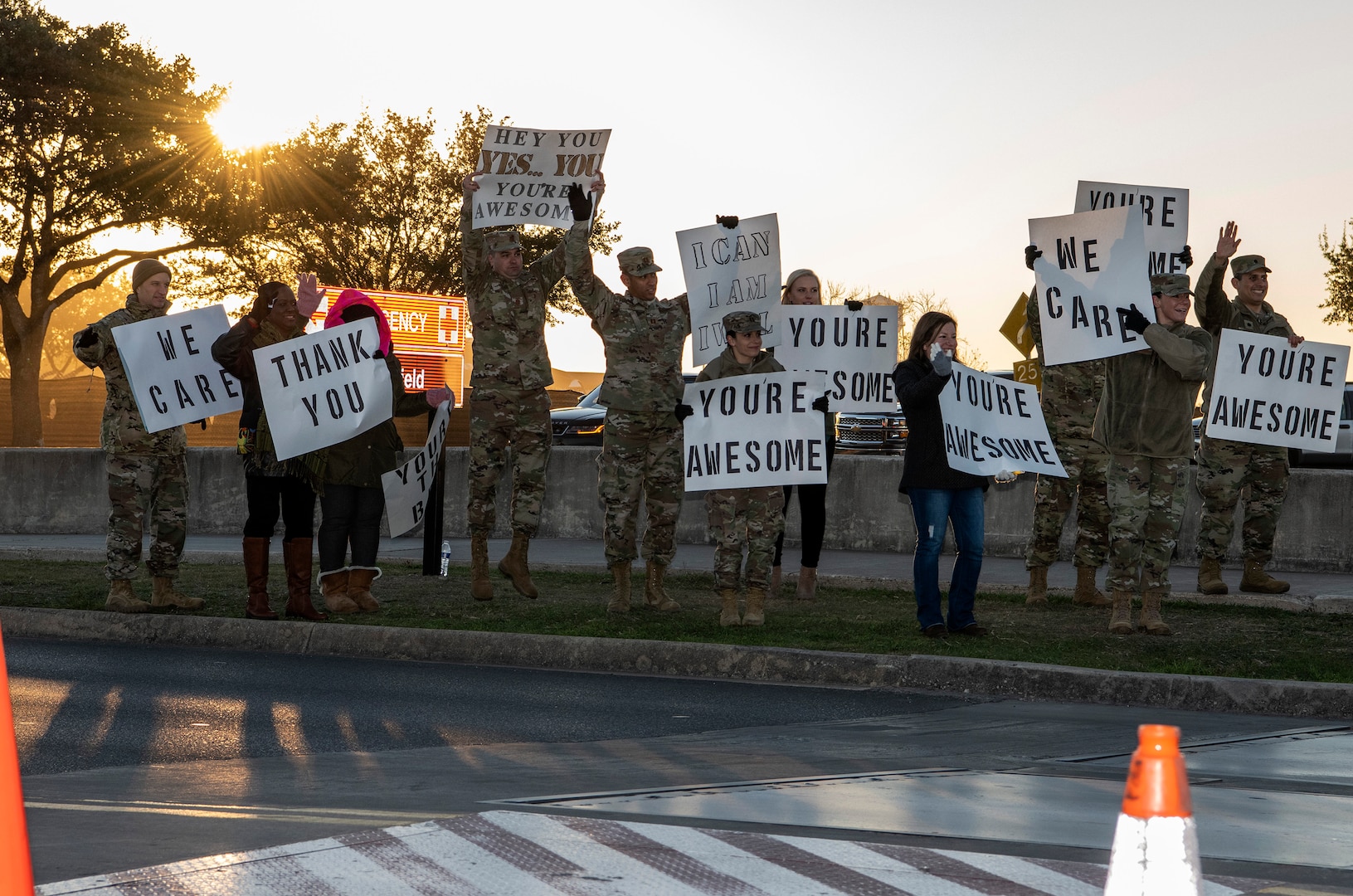 37th Training Wing military and civilian members hold positive messages of support at base gates during the morning inbound commute as part of their new initiative, “We Care,” at Joint Base San Antonio-Lackland, Texas, Dec. 18, 2019. The initiative involved 37th Training Wing military and civilian members spending the morning at various gates letting each person know that they stand together in support of those struggling with depression and thoughts of suicide by holding a positive message of support and handing out over 400 candy canes. If you are struggling with thoughts of suicide, please go directly to the Mental Health Clinic or to your closest Emergency Room. You can also reach the National Suicide Prevention Lifeline at 1-800-273-8255.
