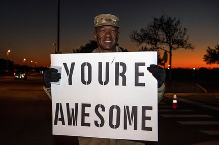 Col. Isaac Davidson, Inter-American Air Forces Academy commandant, holds a positive message of support at a base gate during the morning inbound commute as part of their new initiative, “We Care,” at Joint Base San Antonio-Lackland, Texas, Dec. 18, 2019. The initiative involved 37th Training Wing military and civilian members spending the morning at various gates letting each person know that they stand together in support of those struggling with depression and thoughts of suicide by holding a positive message of support and handing out over 400 candy canes. If you are struggling with thoughts of suicide, please go directly to the Mental Health Clinic or to your closest Emergency Room. You can also reach the National Suicide Prevention Lifeline at 1-800-273-8255.